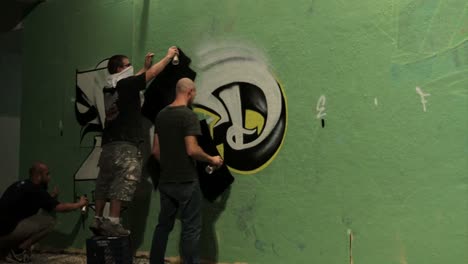 Time-lapse-shot-of-graffiti-being-sprayed-on-a-wall-by-taggers