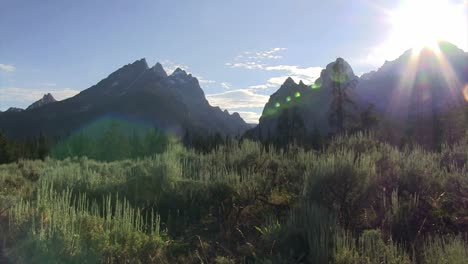 Pan-across-the-sun-peeking-above-the-Grand-Tetons-mountains