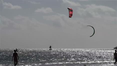 People-engage-in-kite-boarding--along-a-sunny-coast