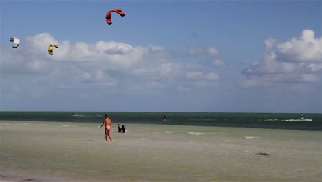 People-engage-in-the-fast-moving-sport-kite-boarding--along-a-sunny-coast-1