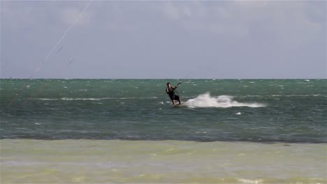 People-engage-in-the-fast-moving-sport-kite-boarding--along-a-sunny-coast-3