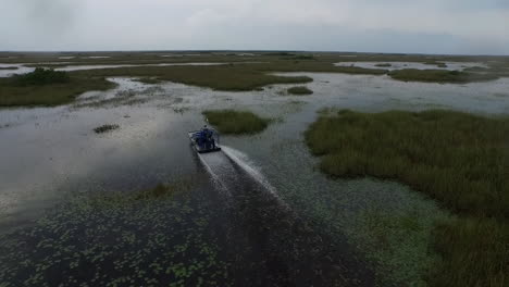 A-beautiful-aerial-shot-over-an-airboat-traveling-through-the-Everglades-in-Florida-1