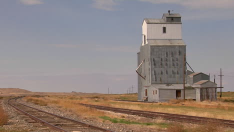 An-Abandoned-Grain-Elevator-Stands-Along-A-Stretch-Of-Railway-Track