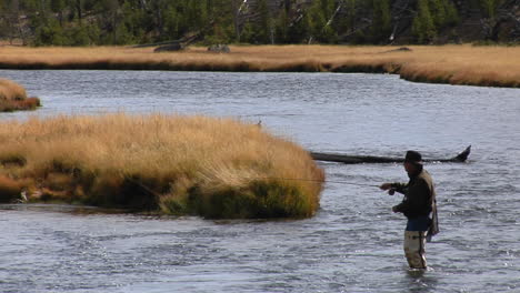 A-Fly-Fisherman-Casts-His-Line-Into-A-Flowing-River