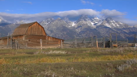 An-Old-Barn-Rises-Out-Of-A-Prairie-With-The-Grand-Tetons-In-The-Background