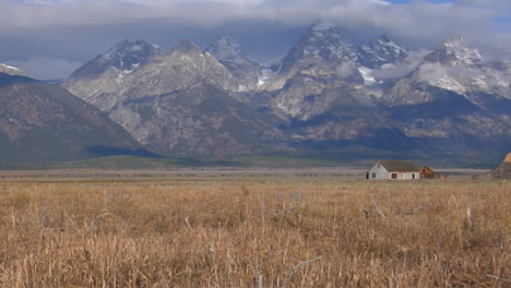 An-Old-Barn-Rises-Out-Of-A-Prairie-With-The-Grand-Tetons-In-The-Background-7