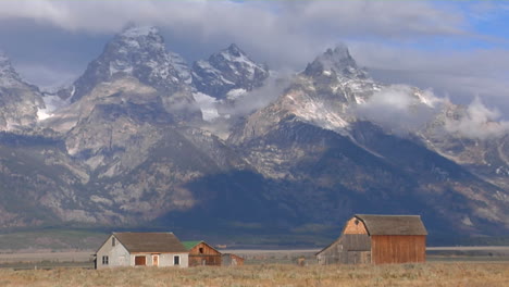 An-Old-Barn-Rises-Out-Of-A-Prairie-With-The-Grand-Tetons-In-The-Background-8
