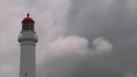 A-Lighthouse-Stands-With-An-Overcast-Sky-In-The-Background