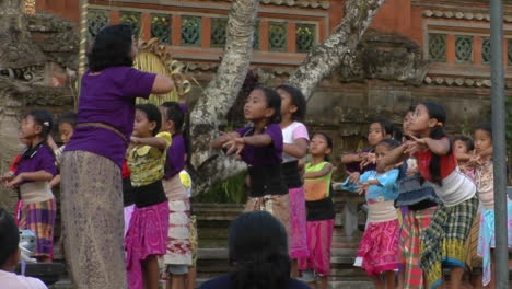 A-Woman-Leads-A-Group-Of-Girls-In-Dance-Movements-At-An-Indonesian-Ceremony