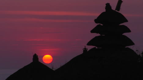 The-Pura-Tanah-Lot-Temple-Stands-In-Silhouette-Against-A-Glowing-Sky-3