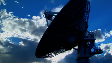 A-Satellite-Dish-Is-Silhouetted-Against-The-Sky
