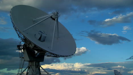 A-Satellite-Dish-Moves-In-Time-Lapse-Against-A-Beautiful-Sky