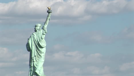 The-Statue-Of-Liberty-Against-A-Cloudy-Sky