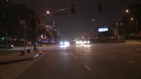 A-Car-Travels-Along-A-Street-At-Night-In-Century-City-Los-Angeles-As-Seen-Through-The-Rear-Window-1