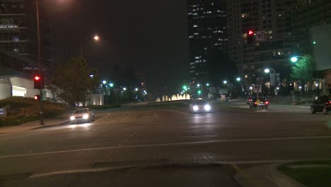 A-Car-Travels-Along-A-Street-At-Night-In-Century-City-Los-Angeles-As-Seen-Through-The-Rear-Window-2