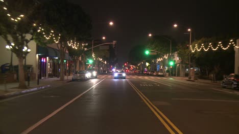 A-Car-Travels-Along-A-Street-At-Night-In-Santa-Monica-California-As-Seen-Through-The-Rear-Window-3