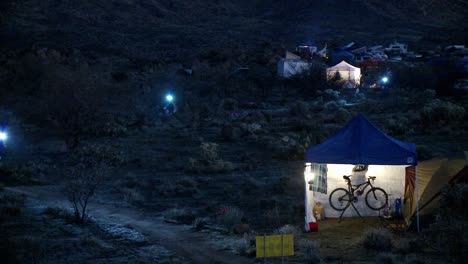 People-ride-bicycles-at-night-at-a-campsite