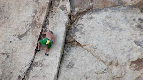 A-young-man-climbs-up-a-mountainside