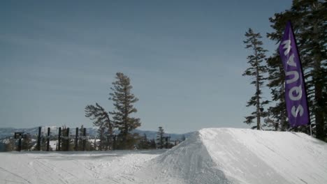 A-snow-boarder-hits-a-bank-of-snow-and-gets-air