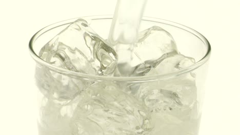 Clear-carbonated-liquid-is-poured-over-ice-into-a-glass