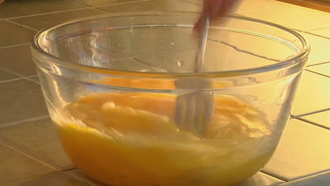 Raw-eggs-are-stirred-in-a-glass-bowl-1