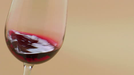 Red-wine-swirling-in-an-elegant-wine-glass