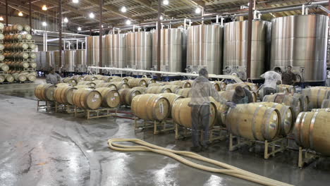 A-cellar-crew-tops-off-wine-barrels-during-harvest-in-California-wine-country-1