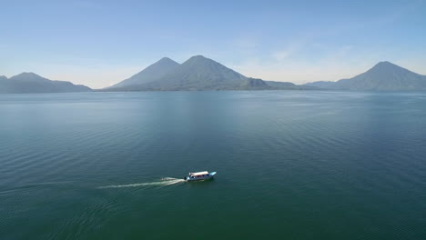 Aerial-over-a-boat-on-Lake-Amatitlan-in-Guatemala-reveals-the-Pacaya-Volcano-in-the-distance-2