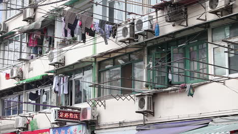 Laundry-hangs-out-to-dry-on-traditional-poles-from-apartment-buildings-in-Shanghai-China