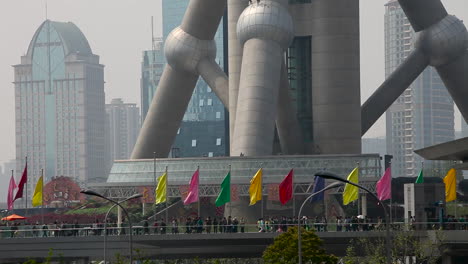 Pedestrians-walk-along-the-base-of-modern-buildings-on-the-waterfront-in-Shanghai-China