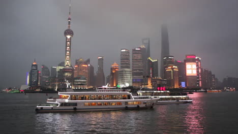 The-vivid-night-skyline-of-Shanghai-China-with-river-traffic-foreground-3