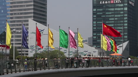 Pedestrians-walk-along-the-base-of-modern-buildings-on-the-waterfront-in-Shanghai-China-1