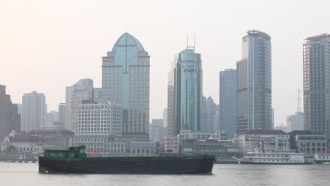 A-barge-travels-on-the-Pearl-River-in-Shanghai-China-on-a-hazy-day