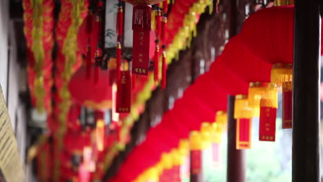 Lanterns-and-tassels-hang-from-the-rafters-in-a-Buddhist-temple-in-China