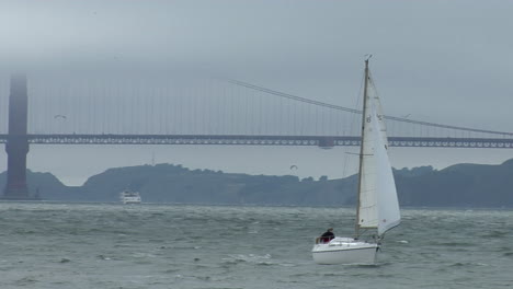 A-sailboat-coasts-near-the-Golden-Gate-Bridge-on-a-windy-day