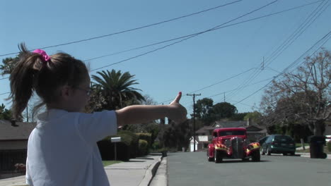 A-girl-hitchhikes-on-a-residential-street