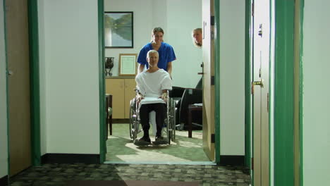 A-nurse-wheels-a-patient-down-a-hallway