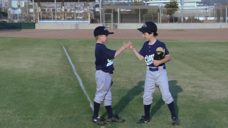 Little-league-baseball-players-give-each-other-playful-handshakes
