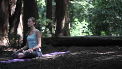 A-young-woman-practices-yoga-in-a-quiet-forest