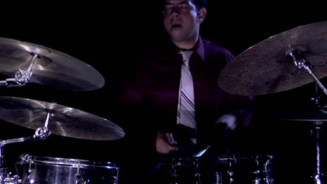 A-drum-set-sits-on-a-dark-stage-1