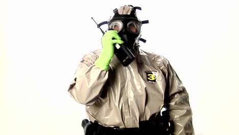 A-man-in-a-hazmat-suit-speaks-into-a-walkietalkie