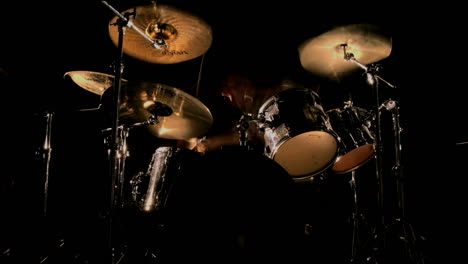 A-drummer-plays-on-a-darkened-stage