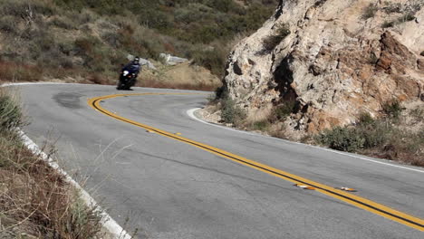 Motorcycle-and-cars-on-winding-mountain-road