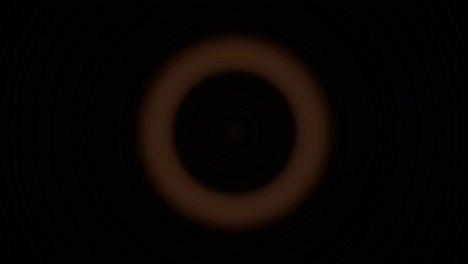 Bright-orange-circles-flash-and-recede-against-a-black-background