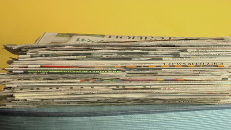 Newspapers-stack-up-on-a-table-in-time-lapse