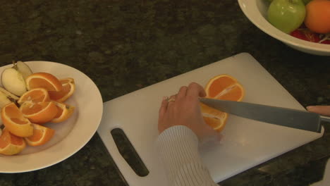 A-woman-slices-oranges-on-a-cutting-board
