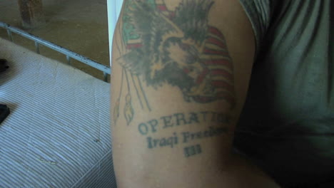 A-soldiers-arm-bares-a-tattoo-of-an-American-flag-and-bald-eagle