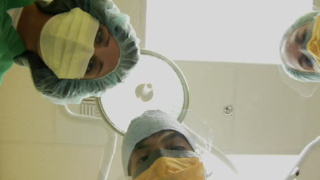 Surgeons-look-down-on-a-patient-and-use-instruments-in-this-POV-shot
