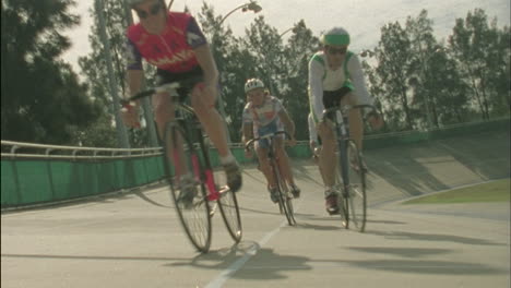 A-group-of-cyclists-ride-around-a-track-1
