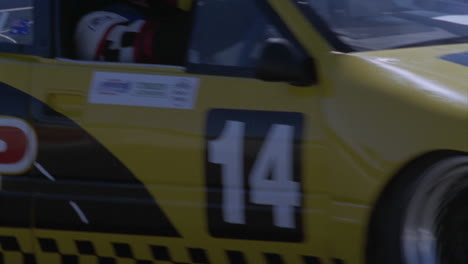 A-yellow-racing-car-drives-around-a-race-track